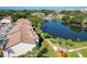 Aerial view of condo buildings next to lake, pool, and lush landscape at 6 Escondido Cir # 64, Altamonte Springs, FL 32701