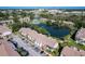 Aerial view of the community showcasing a lake, pool, ample parking, and lush landscaping at 6 Escondido Cir # 64, Altamonte Springs, FL 32701