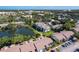 Community aerial view featuring a scenic lake, mature trees, pool area, and well-maintained landscaping at 6 Escondido Cir # 64, Altamonte Springs, FL 32701