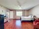 Inviting bedroom with wood floors, neutral walls, and a cozy chair by the window at 6 Escondido Cir # 64, Altamonte Springs, FL 32701