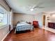 Comfortable bedroom featuring wood floors, ceiling fan, and adjoining bathroom for convenience at 6 Escondido Cir # 64, Altamonte Springs, FL 32701