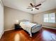 Cozy bedroom features wood floors, ceiling fan, and natural light from the window at 6 Escondido Cir # 64, Altamonte Springs, FL 32701