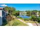 Scenic view from the condo featuring a serene lake, lush greenery, and landscaped walkways at 6 Escondido Cir # 64, Altamonte Springs, FL 32701