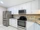 Updated kitchen boasts stainless steel appliances and white cabinets, perfect for modern living at 6 Escondido Cir # 64, Altamonte Springs, FL 32701