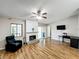 Cozy living room featuring hardwood floors, a fireplace, and a comfortable armchair at 6 Escondido Cir # 64, Altamonte Springs, FL 32701