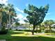 Scenic view of a community pond reflecting surrounding lush greenery and residential buildings at 6 Escondido Cir # 64, Altamonte Springs, FL 32701