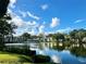 Beautiful pond view reflecting surrounding community homes under a partly cloudy sky at 6 Escondido Cir # 64, Altamonte Springs, FL 32701
