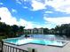 Community pool with lake backdrop and lush landscape at 6 Escondido Cir # 64, Altamonte Springs, FL 32701