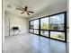 Bright sunroom featuring tile floors, large windows, and serene views of the surrounding landscape at 6 Escondido Cir # 64, Altamonte Springs, FL 32701