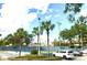 Well maintained tennis court with palm trees and parking in the background on a sunny day at 6 Escondido Cir # 64, Altamonte Springs, FL 32701