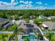 An aerial view of a home with solar panels and a screened-in pool in a suburban neighborhood at 610 Carey Way, Orlando, FL 32825