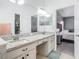 Dual sink vanity area with granite countertops and a separate tub and shower area with access to the bedroom at 610 Carey Way, Orlando, FL 32825