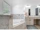 Separate tub and sink vanity area featuring a large window and a granite countertop at 610 Carey Way, Orlando, FL 32825