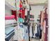 View of a walk-in closet, fully equipped with shelves and hanging rods for optimal storage and organization at 610 Carey Way, Orlando, FL 32825