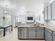 Open kitchen featuring stainless steel dishwasher and view to dining and living areas at 610 Carey Way, Orlando, FL 32825