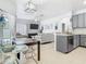 Open floor plan featuring modern gray cabinets, a dining area, and a bright living space at 610 Carey Way, Orlando, FL 32825