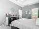 This main bedroom boasts plush carpeting, a gray dresser and includes a tray ceiling with access to the bathroom at 610 Carey Way, Orlando, FL 32825