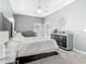 This main bedroom boasts plush carpeting, a tray ceiling, and includes a gray dresser and headboard at 610 Carey Way, Orlando, FL 32825