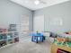 Bright playroom with carpet, a blue table, and ample storage for toys at 610 Carey Way, Orlando, FL 32825