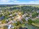Aerial view of a lush neighborhood with mature trees, single-Gathering homes, and serene lakes at 650 Sweetbriar Br, Longwood, FL 32750