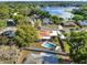 Aerial of a private backyard oasis with a sparkling pool and mature landscaping, near the lake at 650 Sweetbriar Br, Longwood, FL 32750