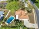 Aerial view of backyard features a private pool, patio, and lush greenery on a sunny day at 650 Sweetbriar Br, Longwood, FL 32750