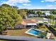 Aerial showcases a private pool, screened lanai, lush landscaping, and proximity to the lake at 650 Sweetbriar Br, Longwood, FL 32750