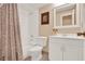 Traditional bathroom with white vanity, bathtub and a floral shower curtain at 650 Sweetbriar Br, Longwood, FL 32750
