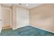 Bedroom featuring a closet with louvered doors and blue carpeted floors at 650 Sweetbriar Br, Longwood, FL 32750