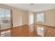 Comfortable bedroom with hardwood floors, two windows, and a closet, ideal for relaxation at 650 Sweetbriar Br, Longwood, FL 32750