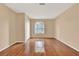 Bright bedroom with hardwood floors, a window, and closet, offering a versatile space at 650 Sweetbriar Br, Longwood, FL 32750