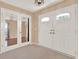 Bright foyer featuring double doors, carpet, and neutral walls, creating a welcoming entry at 650 Sweetbriar Br, Longwood, FL 32750