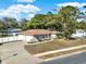 Charming single-story home with a well-manicured lawn and a long private driveway at 650 Sweetbriar Br, Longwood, FL 32750
