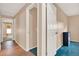 Hallway featuring wood-look flooring, tan walls, and a view into an adjacent room at 650 Sweetbriar Br, Longwood, FL 32750