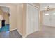Hallway with closet, leading to the main entrance, showcasing a transition between living spaces at 650 Sweetbriar Br, Longwood, FL 32750