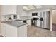 Bright kitchen features white cabinetry, stainless steel appliances, and tile floors at 650 Sweetbriar Br, Longwood, FL 32750