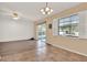 The spacious living room features a window, tile and wood floors, and a sliding glass door at 650 Sweetbriar Br, Longwood, FL 32750