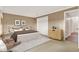 Main bedroom featuring a bed, chair and tan carpet, creating a cozy retreat at 650 Sweetbriar Br, Longwood, FL 32750