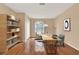 Home office with hardwood floors, a large window, and stylish furniture, perfect for productivity at 650 Sweetbriar Br, Longwood, FL 32750