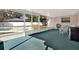 Enclosed patio featuring a seating area overlooking a pool and fenced backyard at 650 Sweetbriar Br, Longwood, FL 32750