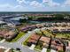 Expansive aerial view of a residential neighborhood with a lake, showcasing the community's layout and surroundings at 7618 Oakmoss Loop, Davenport, FL 33837