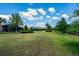 Expansive backyard with lush lawn and well-maintained landscaping offers ample space for outdoor activities at 7618 Oakmoss Loop, Davenport, FL 33837