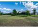 Expansive backyard with lush lawn and well-maintained landscaping offers ample space for outdoor activities at 7618 Oakmoss Loop, Davenport, FL 33837