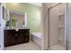 Modern bathroom featuring a soaking tub, a glass-enclosed shower, and a sleek vanity at 7618 Oakmoss Loop, Davenport, FL 33837