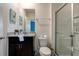 Bathroom with granite counters, a glass-enclosed shower, and artistic decor at 7618 Oakmoss Loop, Davenport, FL 33837