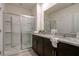 Spacious bathroom featuring dual vanities and a glass-enclosed shower at 7618 Oakmoss Loop, Davenport, FL 33837