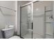 Bright bathroom featuring a glass-enclosed shower and tile accents at 7618 Oakmoss Loop, Davenport, FL 33837