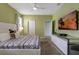 Stylish bedroom with a modern bed, television, and ensuite bathroom for added convenience at 7618 Oakmoss Loop, Davenport, FL 33837
