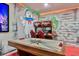 Amazing game room featuring the arcade and a custom themed wall at 7618 Oakmoss Loop, Davenport, FL 33837