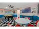 Large game room with vintage decor, offering a pool table, diner-style seating, and a playful atmosphere at 7618 Oakmoss Loop, Davenport, FL 33837